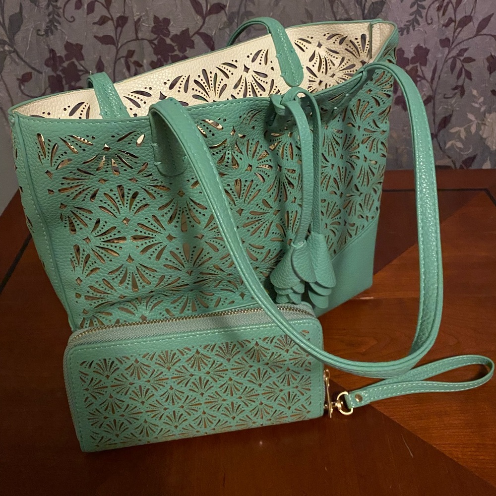 This med size over the shoulder bag is more of a mint green and cream inside